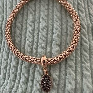 Gold and Black Braided Bracelet with Intricate Charm